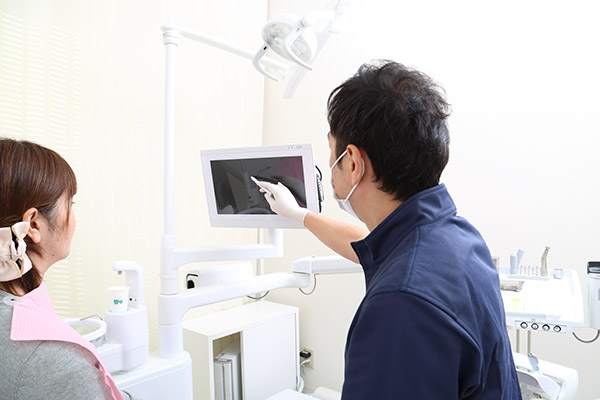 患者さんに説明する歯科医師